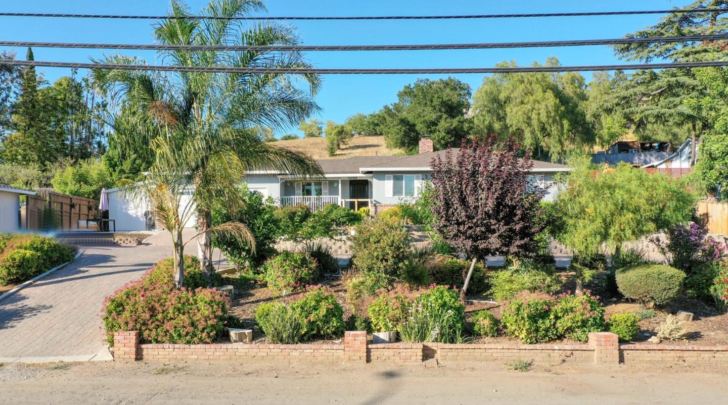 10068 Clayton Road San Jose, CA 95127 - Photo 2 of 34 a front view of a house with a yard and fountain in middle of the road