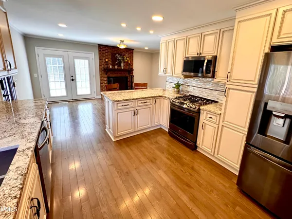 a view of empty room with wooden floor and window