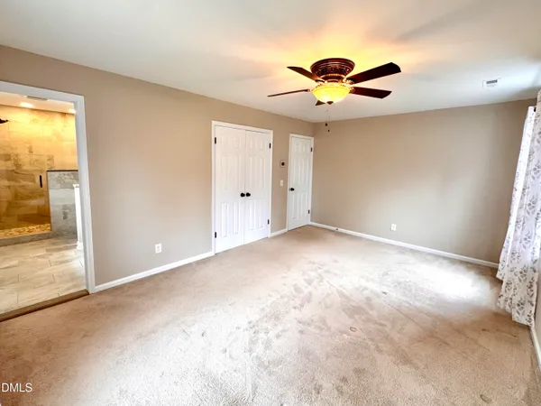 a bathroom with a granite countertop sink a toilet and a mirror