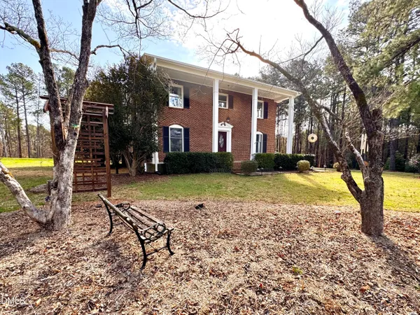 a front view of a building with a garden