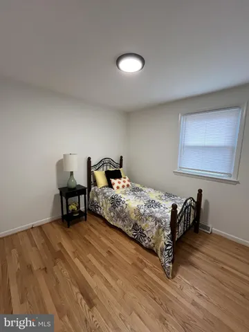 a bedroom with a bed and a chair