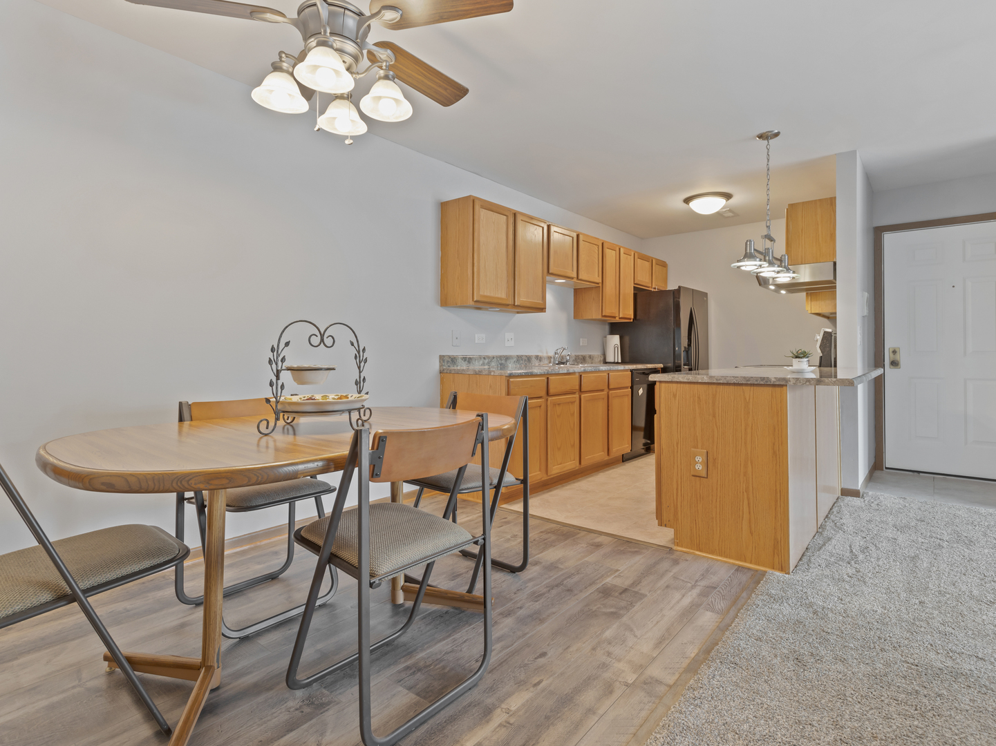 935 Golf Course Road, Unit 7 Crystal Lake, IL 60014 - Photo 7 of 21 a view of a dining room with furniture and wooden floor