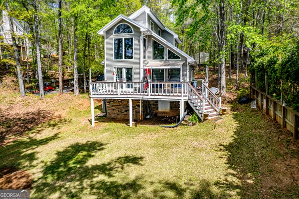 a view of a house with backyard porch and sitting area