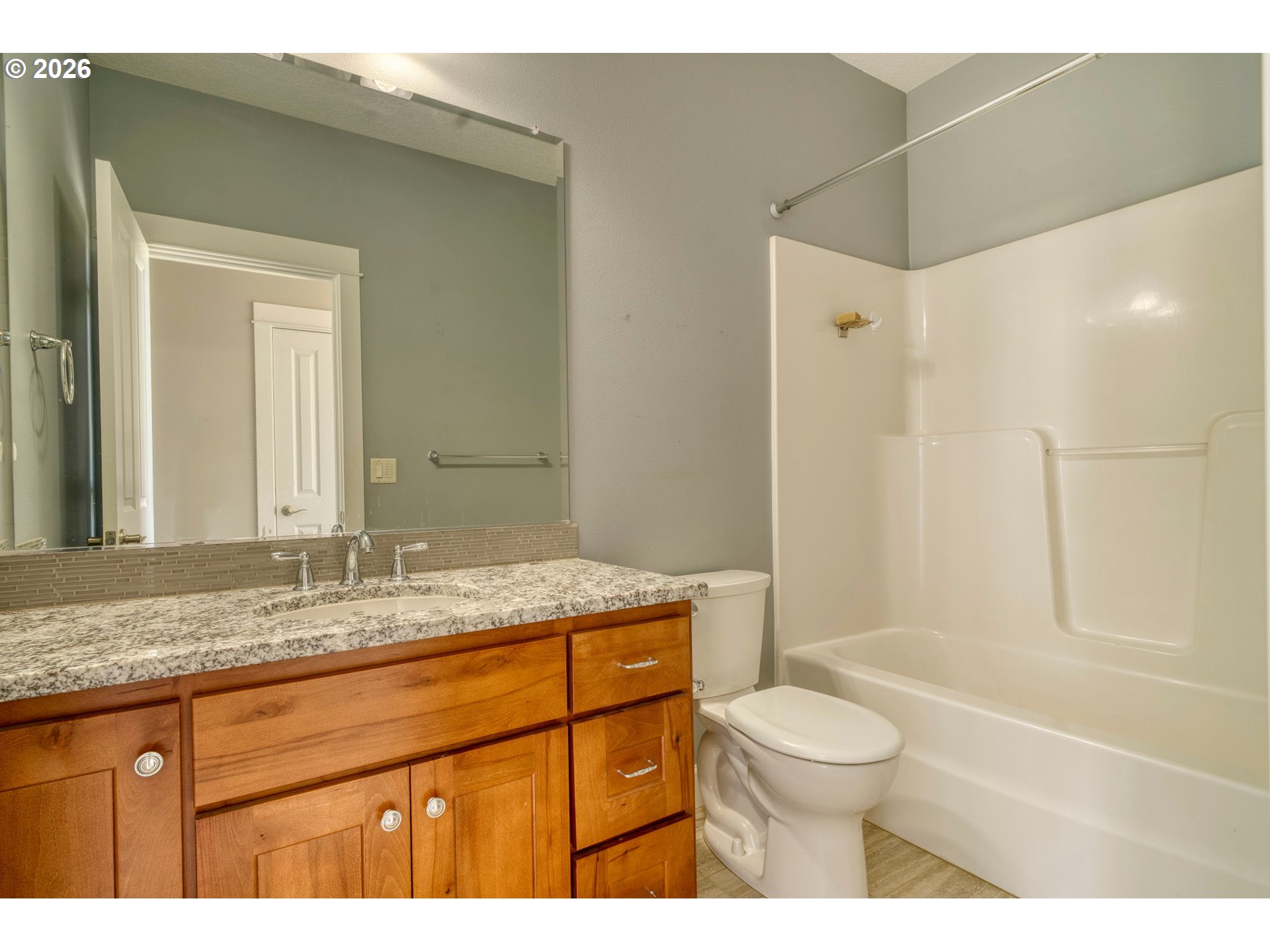 33058 Church Road Warren, OR 97053 - Photo 22 of 45 a bathroom with a granite countertop sink toilet a large mirror a shower and a bathtub