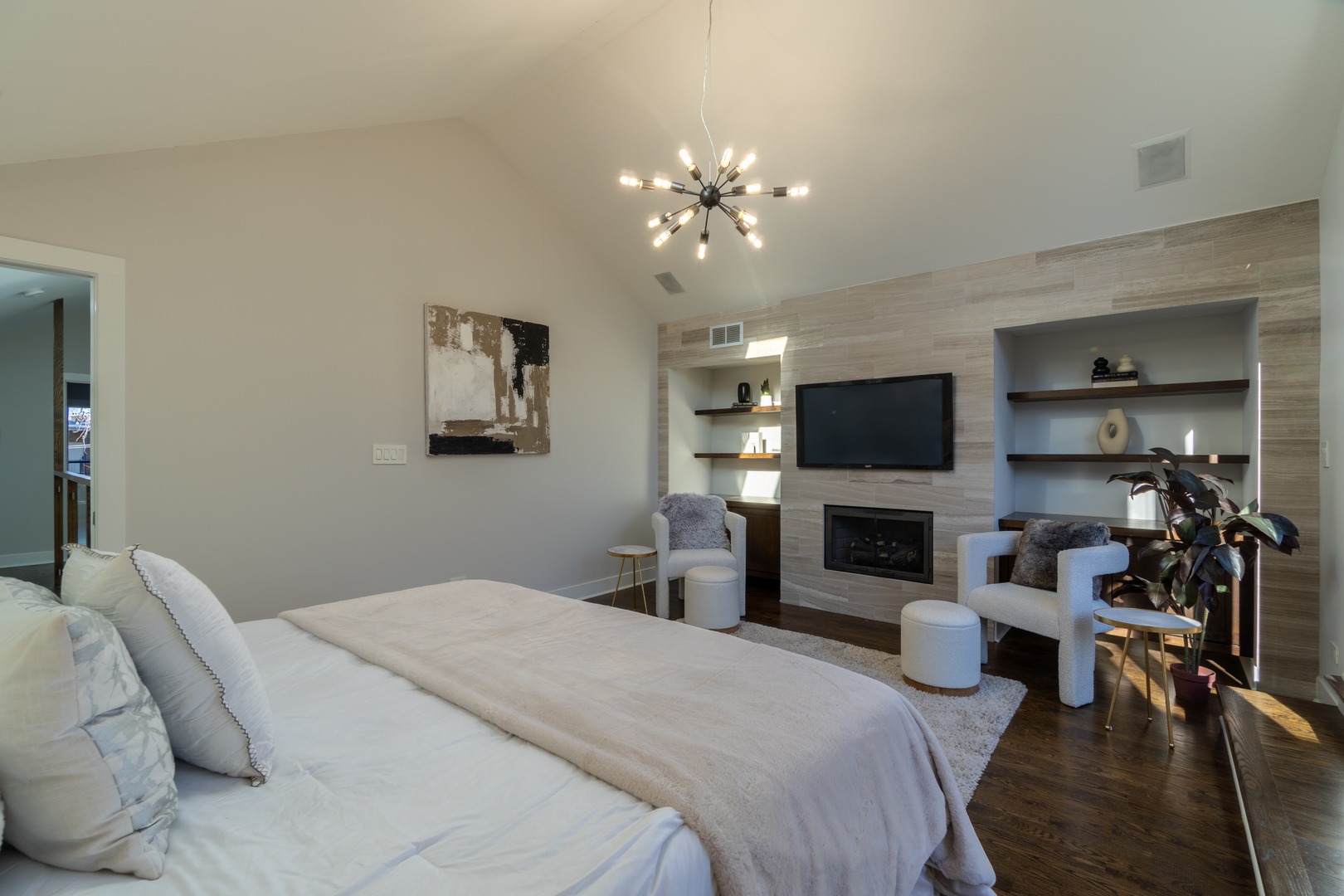 908 North Winchester Avenue Chicago, IL 60622 - Photo 22 of 46 a bedroom with bed a flat tv screen and a fireplace with wooden floor