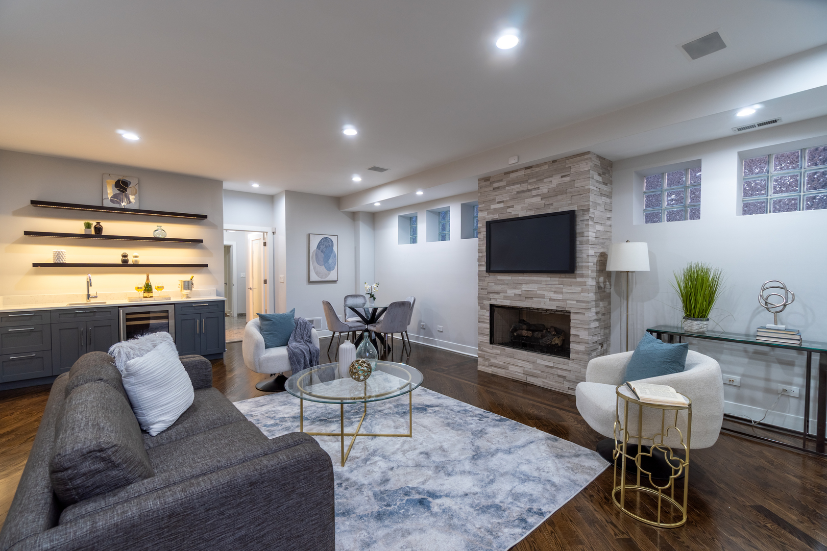 908 North Winchester Avenue Chicago, IL 60622 - Photo 29 of 46 a living room with furniture a fireplace and a flat screen tv