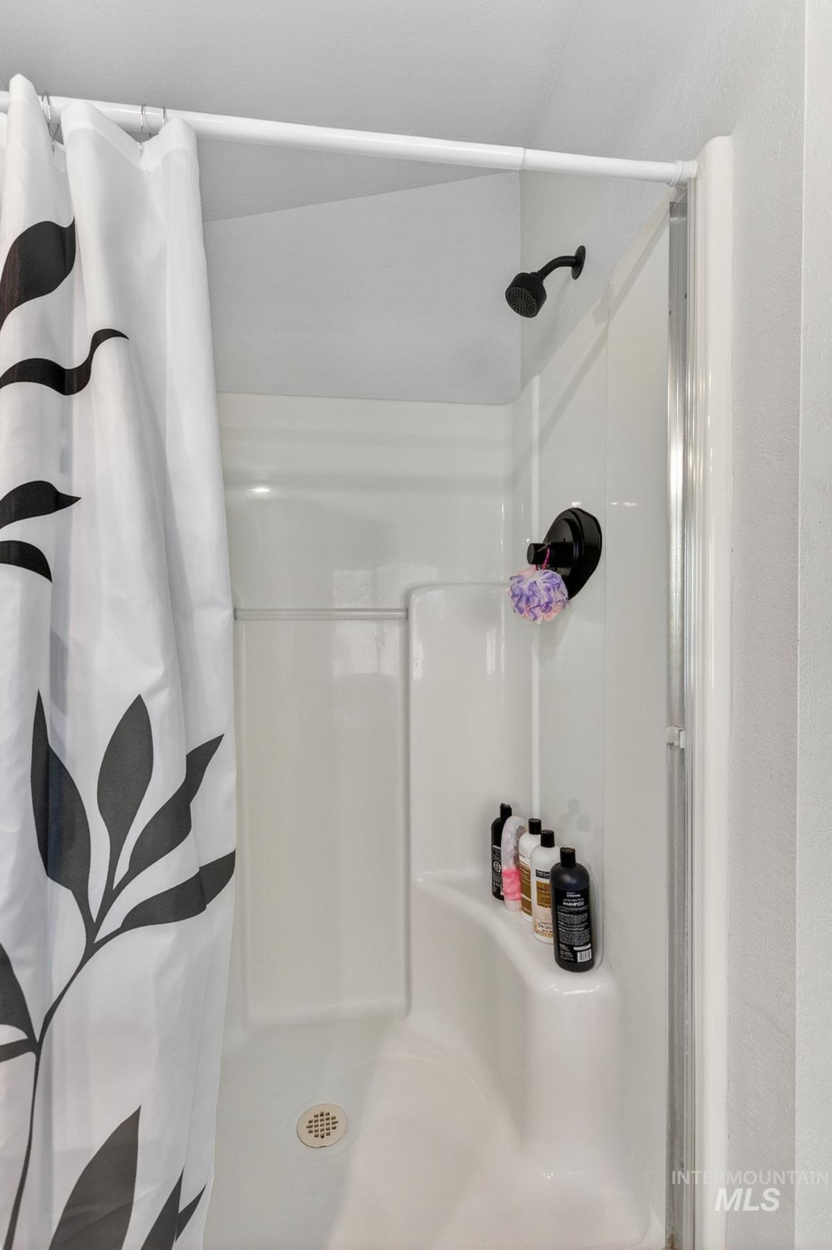 151 Cow Creek Road Lucile, ID 83542 - Photo 28 of 50 White shower enclosure with a dark finish showerhead and control
