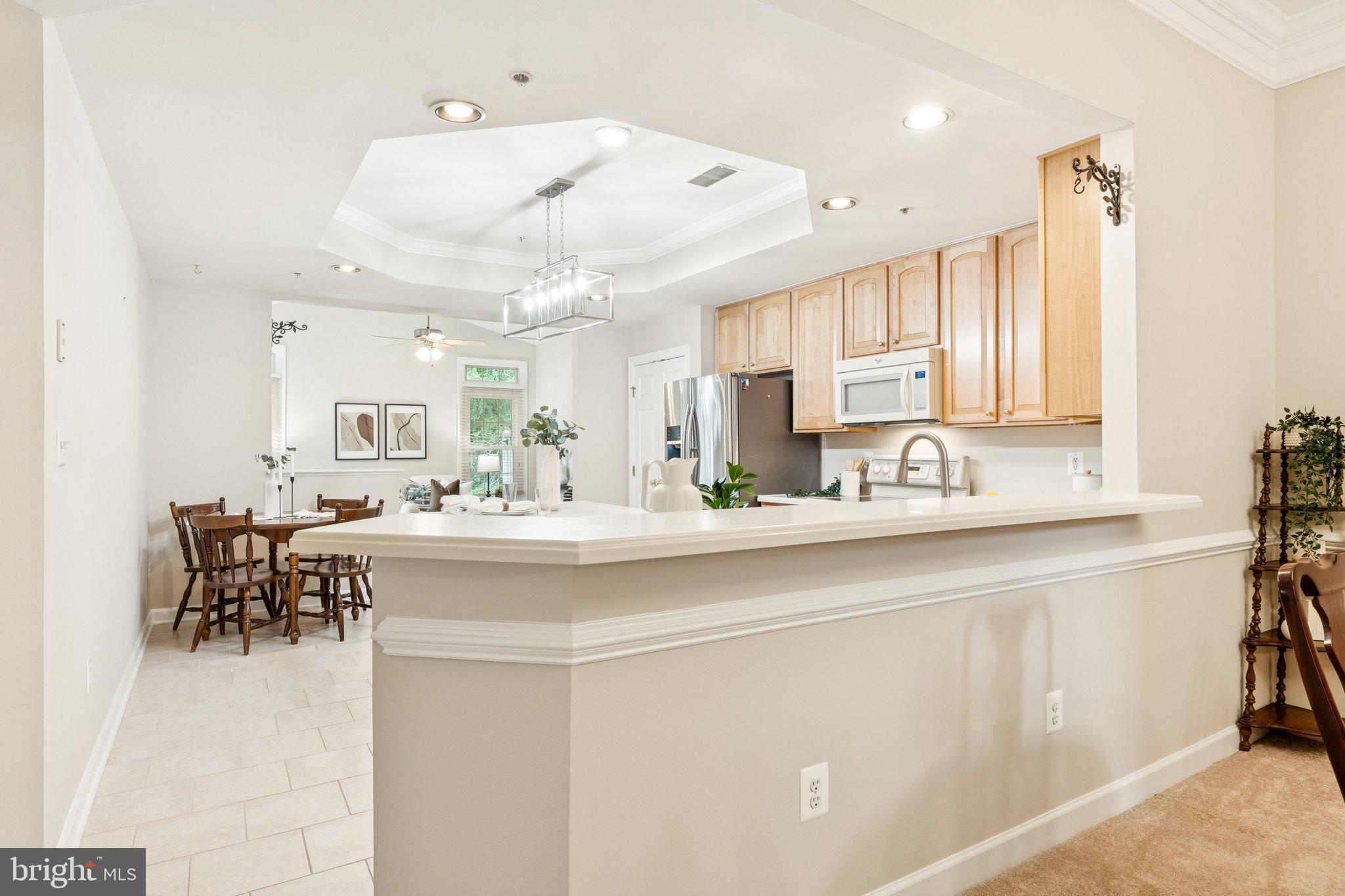 381 Colony Point Place Edgewater, MD 21037 - Photo 11 of 37 a kitchen with kitchen island a sink and chairs