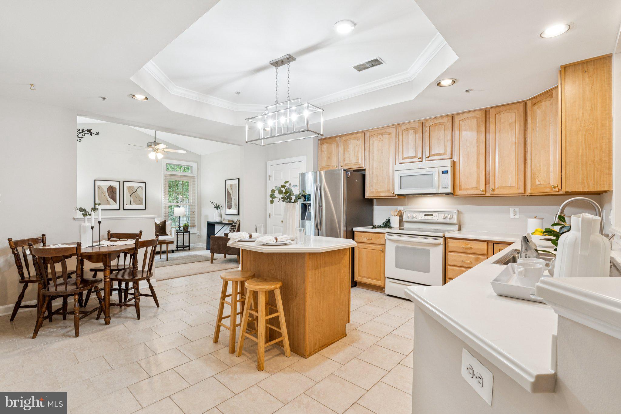 381 Colony Point Place Edgewater, MD 21037 - Photo 12 of 37 a large kitchen with kitchen island a table and chairs in it