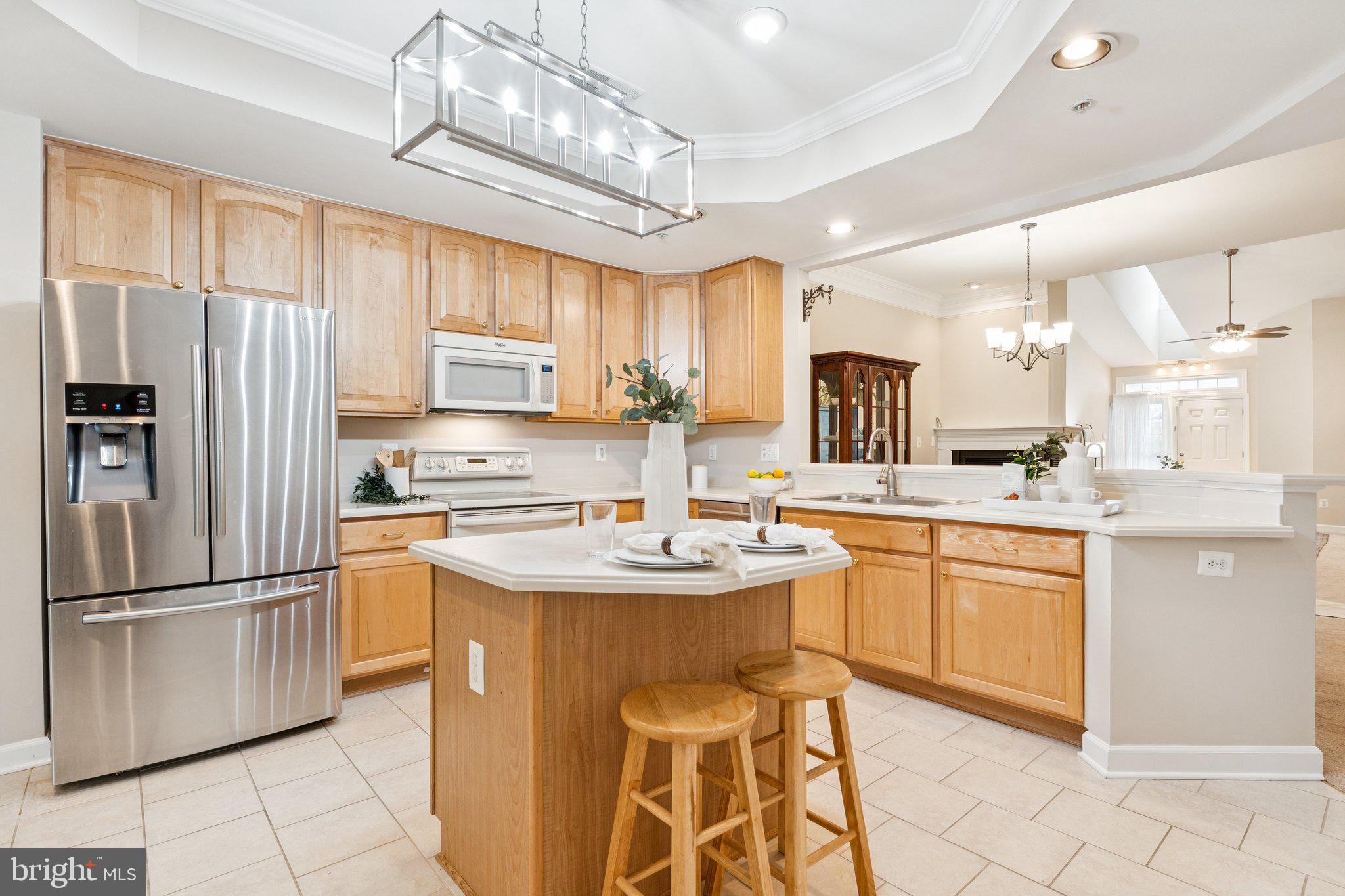 381 Colony Point Place Edgewater, MD 21037 - Photo 13 of 37 a kitchen with stainless steel appliances granite countertop a sink a stove a refrigerator cabinets and chairs