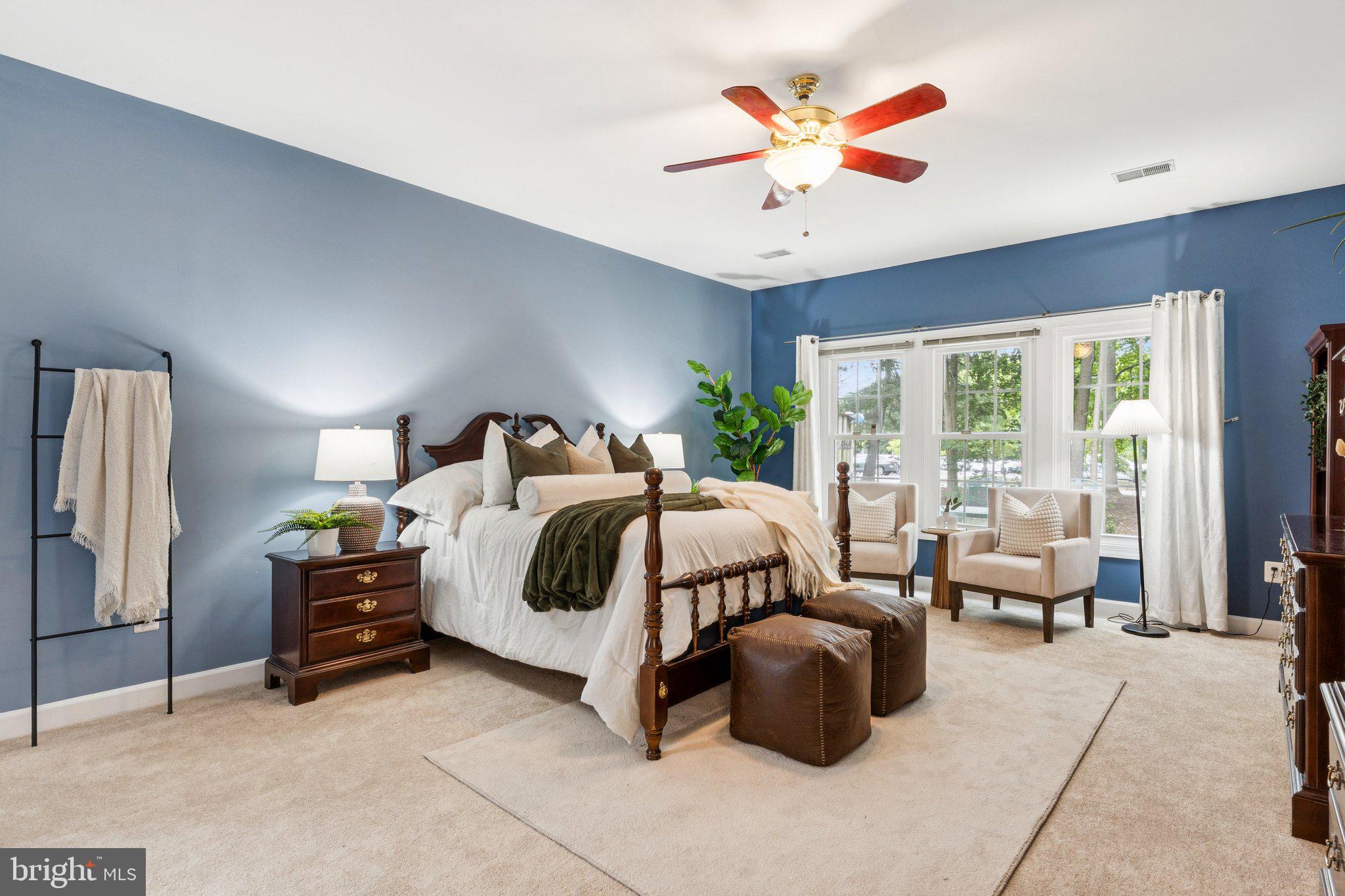 381 Colony Point Place Edgewater, MD 21037 - Photo 19 of 37 a bedroom with a bed a couch and a large window