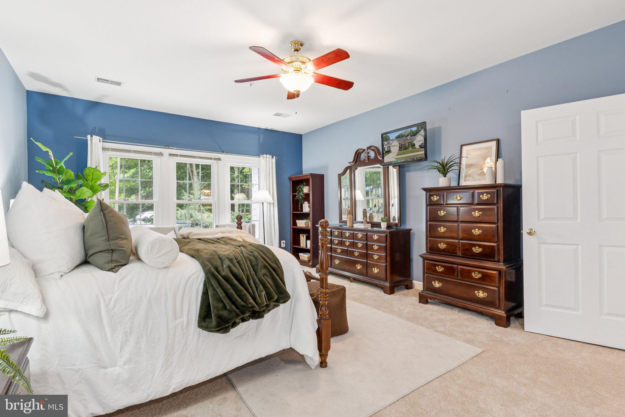 381 Colony Point Place Edgewater, MD 21037 - Photo 20 of 37 a bedroom with a large bed and a bookshelf