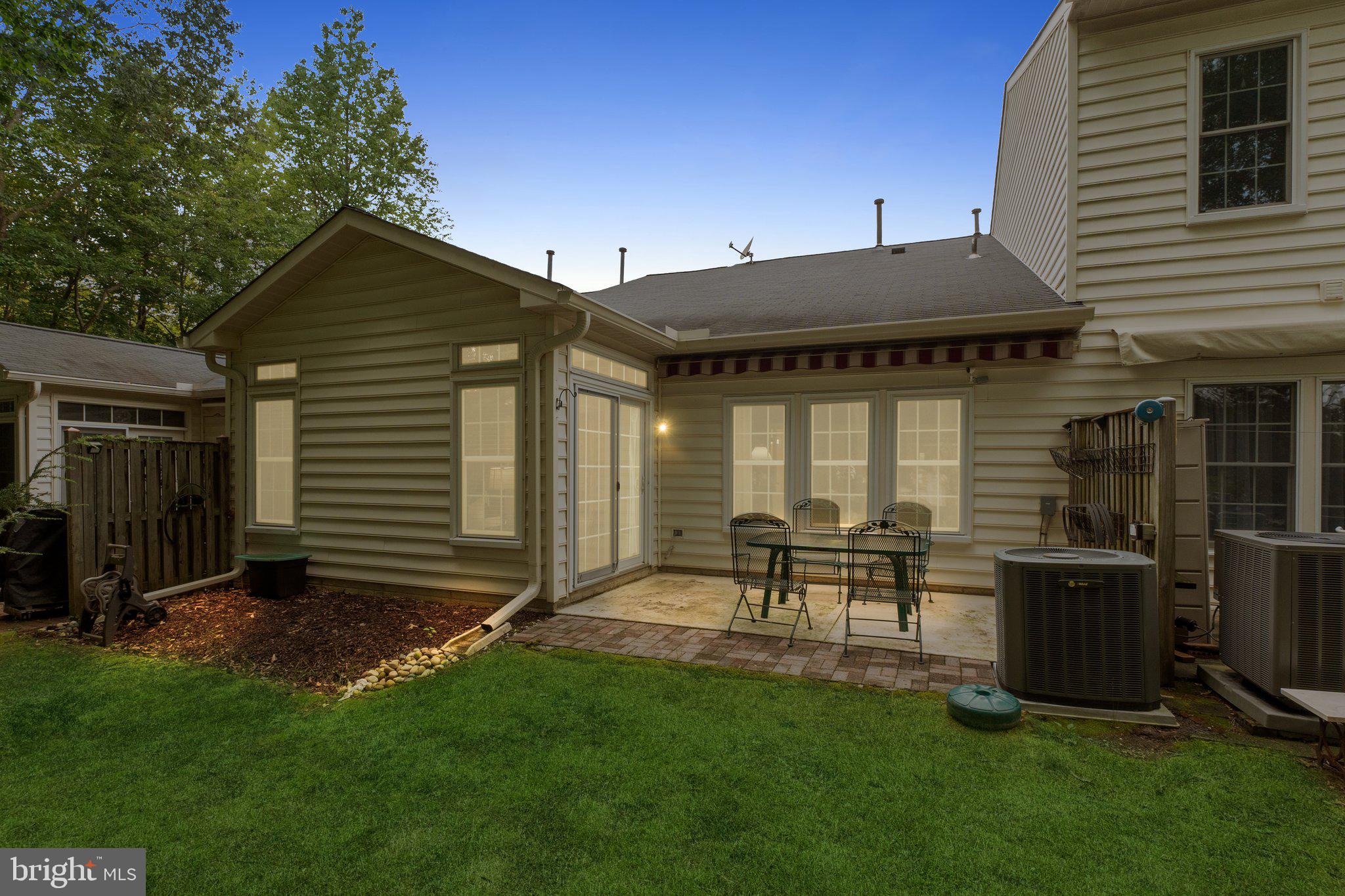 381 Colony Point Place Edgewater, MD 21037 - Photo 3 of 37 a view of backyard with table and chairs and a cabin