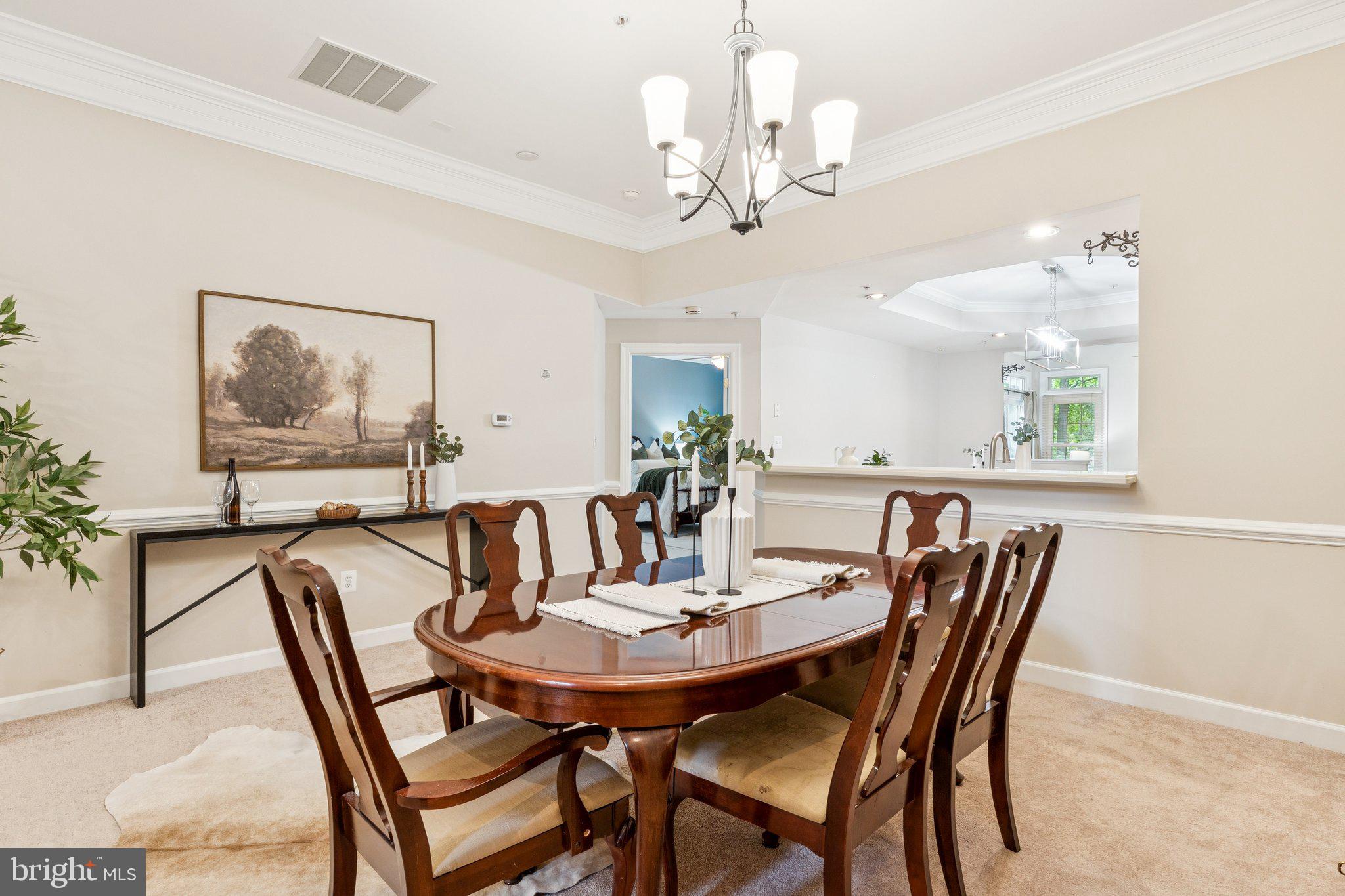 381 Colony Point Place Edgewater, MD 21037 - Photo 10 of 37 a view of a dining room with furniture wooden floor and a chandelier