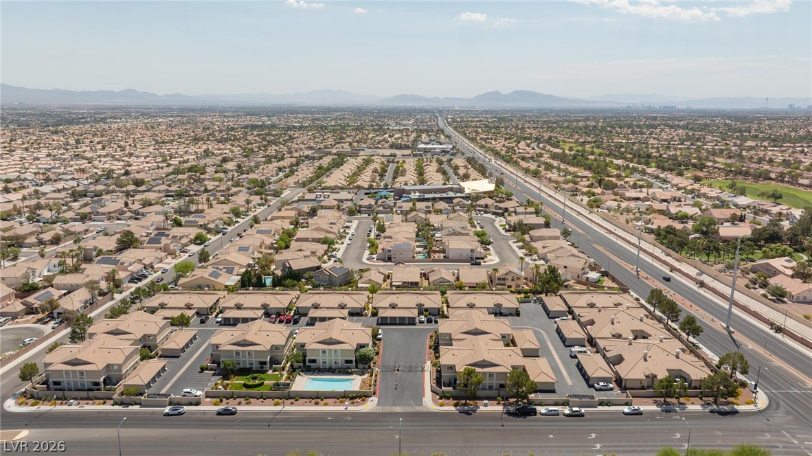 3238 Mystic Ridge Court Las Vegas, NV 89129 - Photo 27 of 31 An aerial perspective showcases a residential neighborhood stretching to the distant mountains.