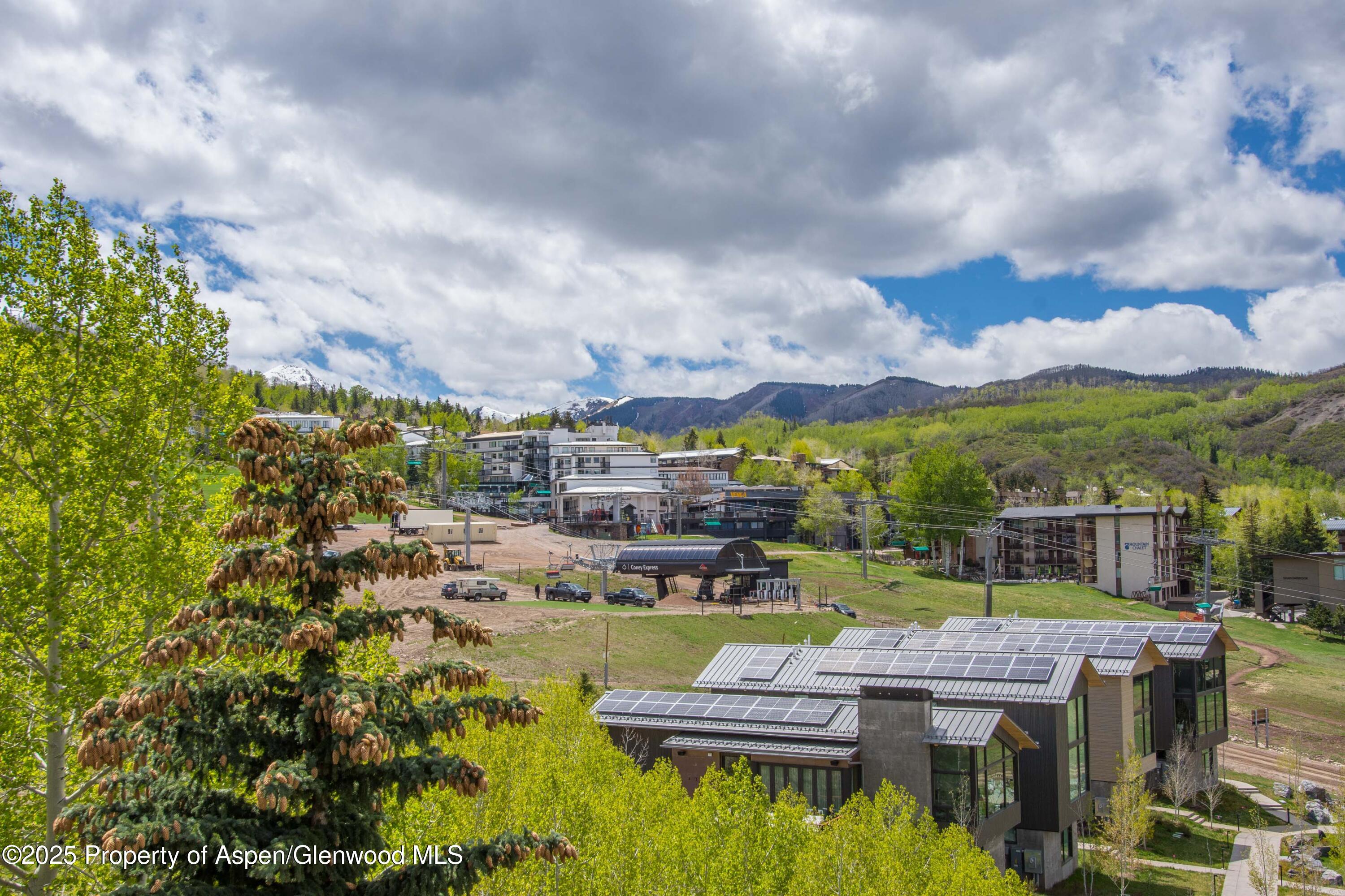 425 Wood Road, Unit 48 Snowmass Village, CO 81615 - Photo 12 of 41 a view of a lake with a house in the background