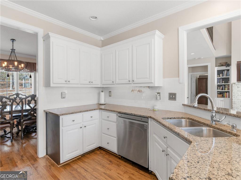 355 Parker Road Covington, GA 30014 - Photo 22 of 60 a kitchen with granite countertop a sink a stove and cabinets