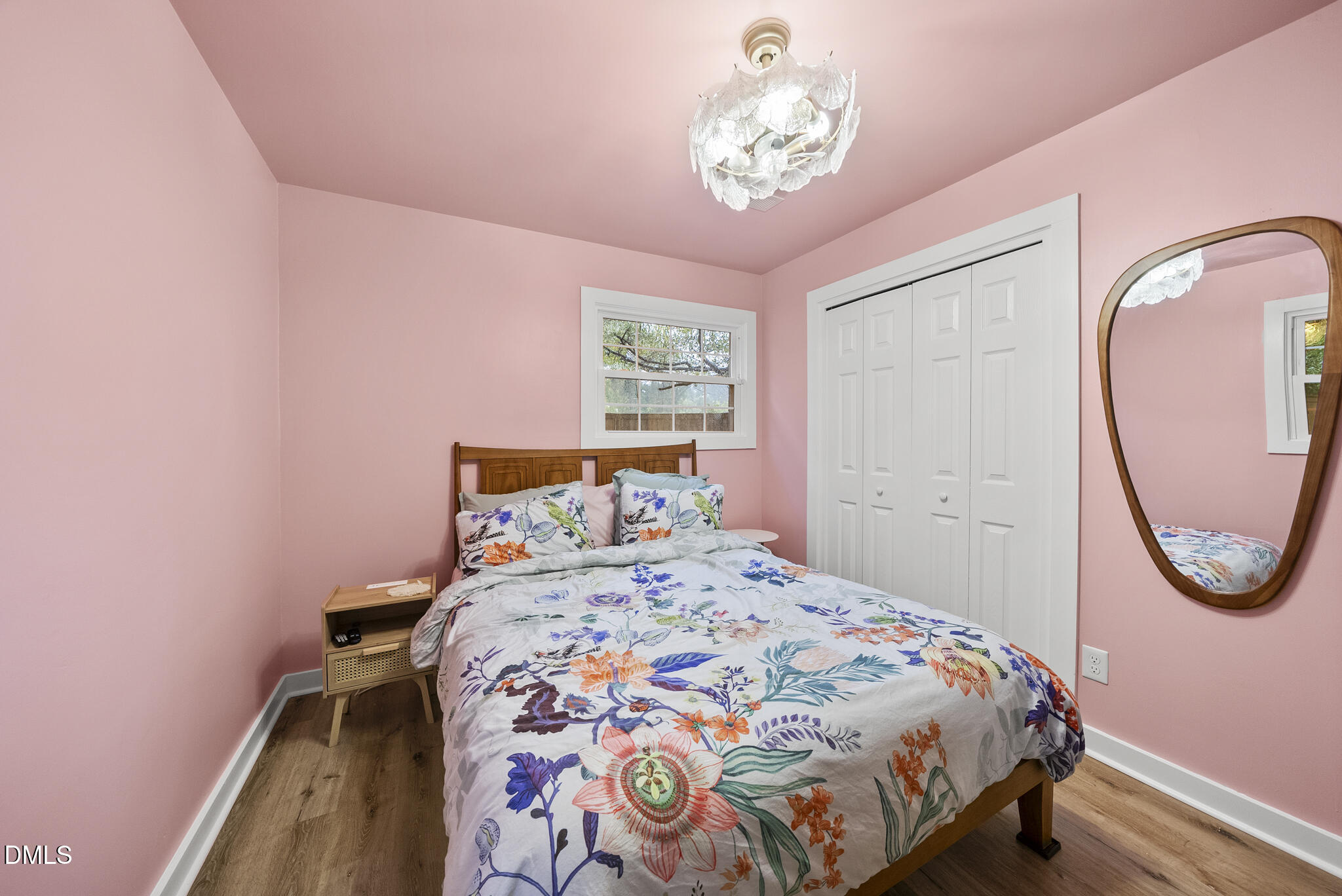 1002 Bacon Street Durham, NC 27701 - Photo 14 of 25 a bedroom with a bed and a chandelier