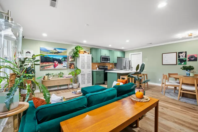 a living room filled with furniture and a wooden floor