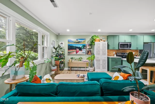 a living room with furniture a rug and a floor to ceiling window