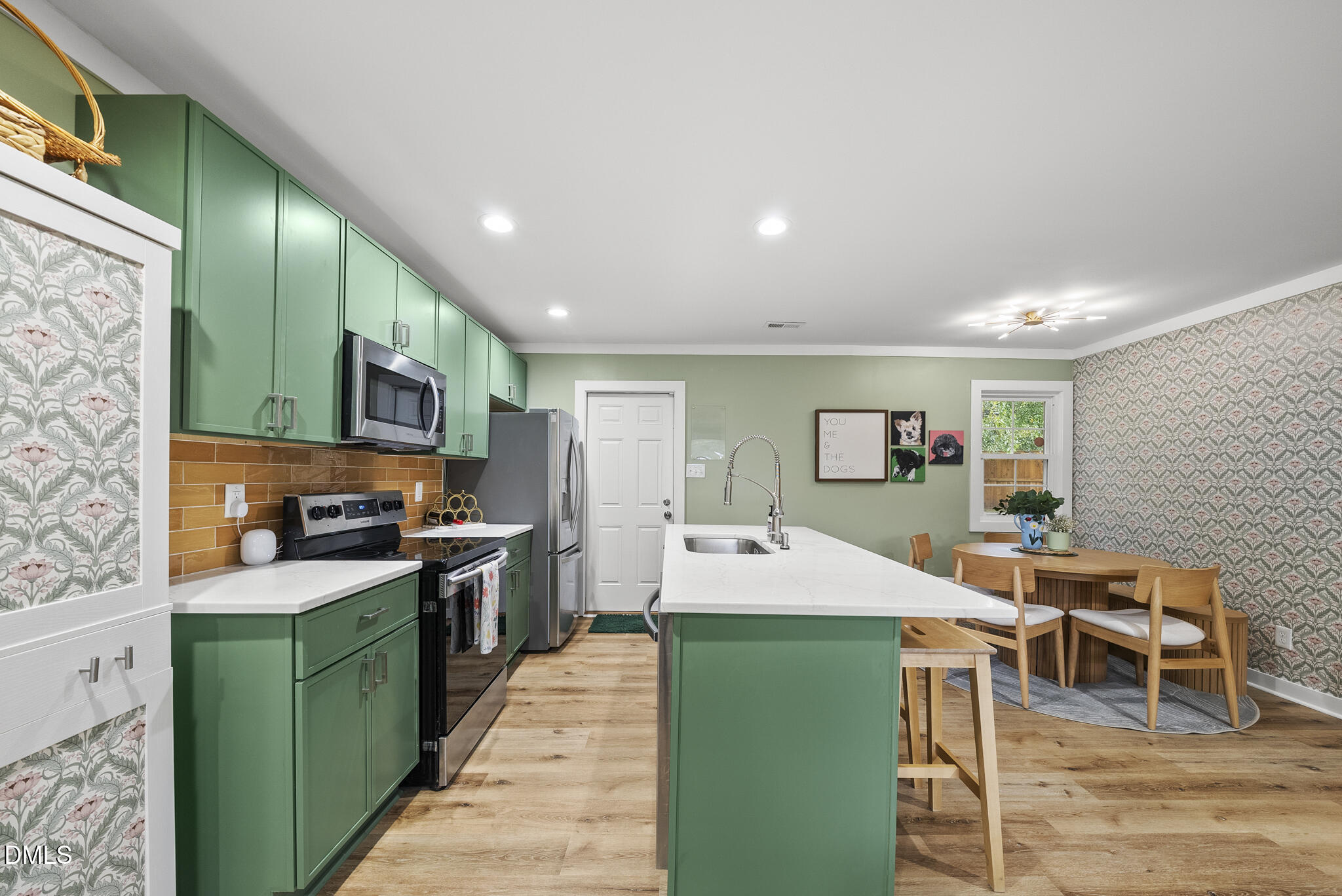 1002 Bacon Street Durham, NC 27701 - Photo 7 of 25 a kitchen with stainless steel appliances kitchen island granite countertop a sink and cabinets