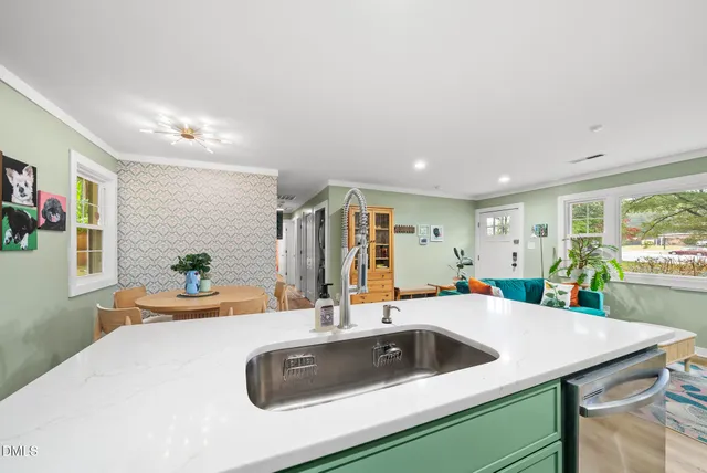 a kitchen with a sink a counter and chairs
