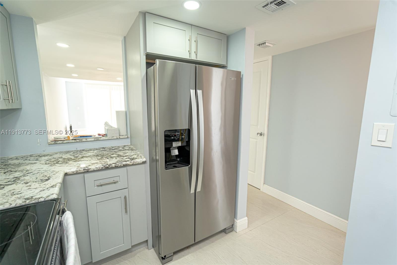 1070 West 43rd Place, Unit 38 Hialeah, FL 33012 - Photo 13 of 25 a kitchen with stainless steel appliances granite countertop a refrigerator and a sink