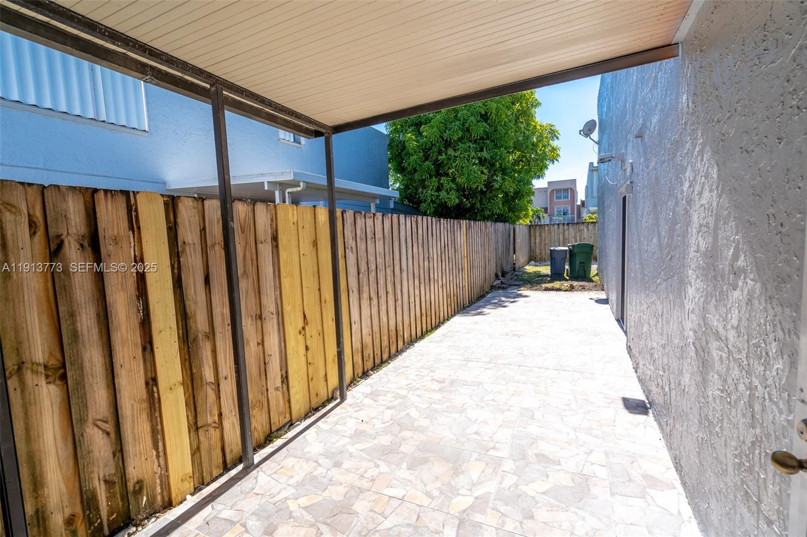 1070 West 43rd Place, Unit 38 Hialeah, FL 33012 - Photo 14 of 25 a view of a wooden fence