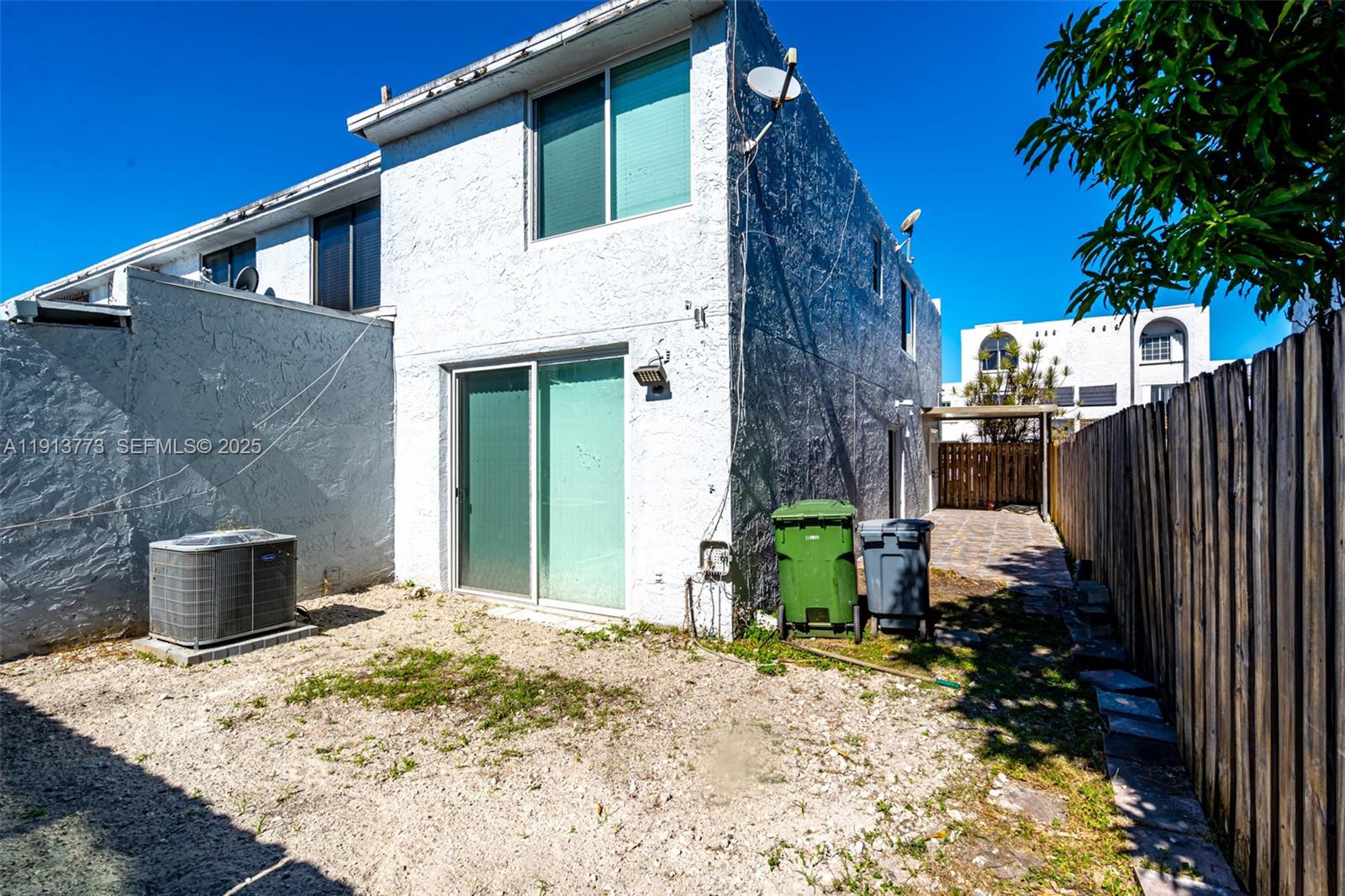 1070 West 43rd Place, Unit 38 Hialeah, FL 33012 - Photo 16 of 25 a backyard of a house with seating space