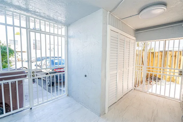 a view of a room with furniture and wooden floor