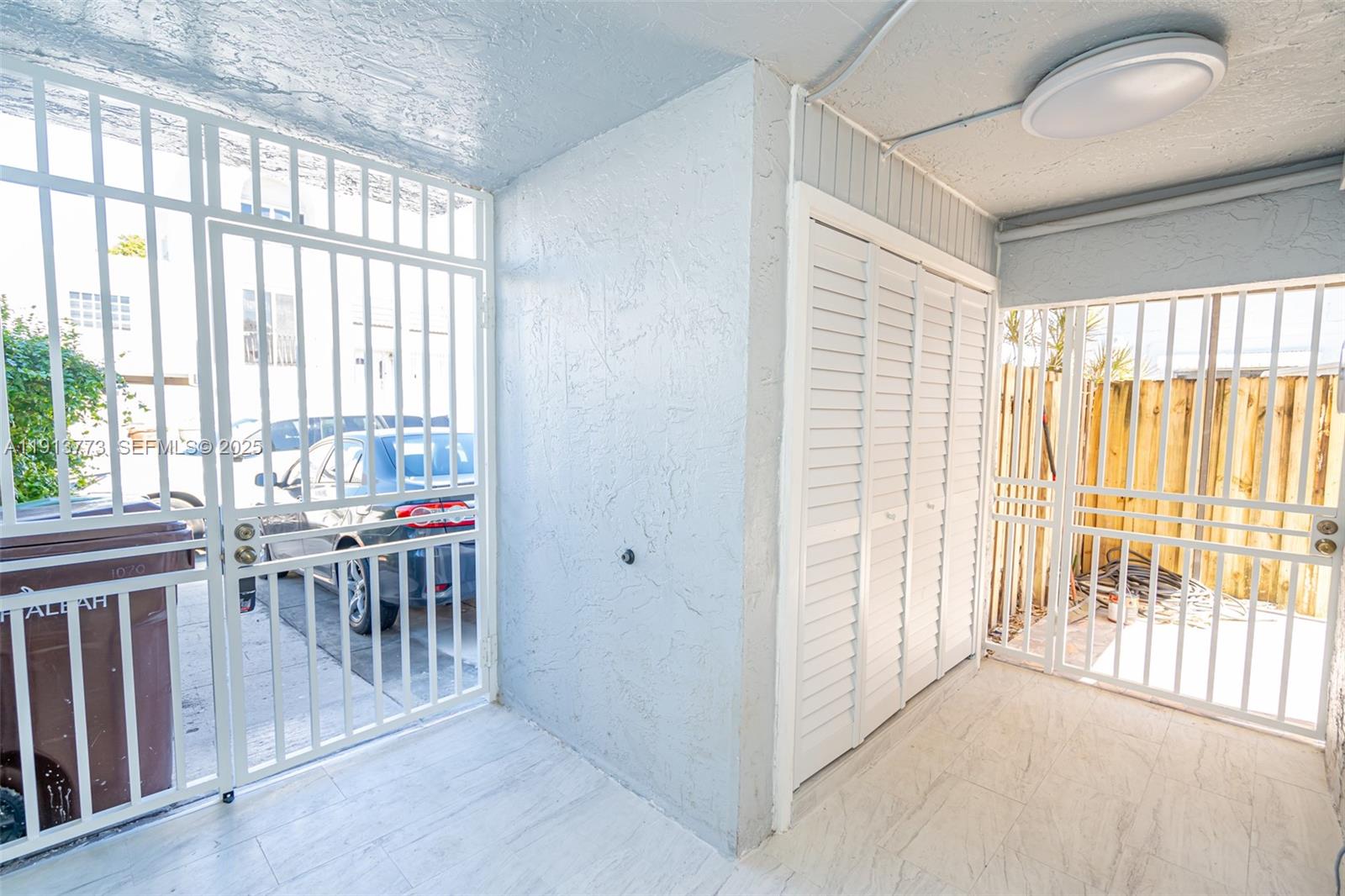 1070 West 43rd Place, Unit 38 Hialeah, FL 33012 - Photo 17 of 25 a view of a room with furniture and wooden floor