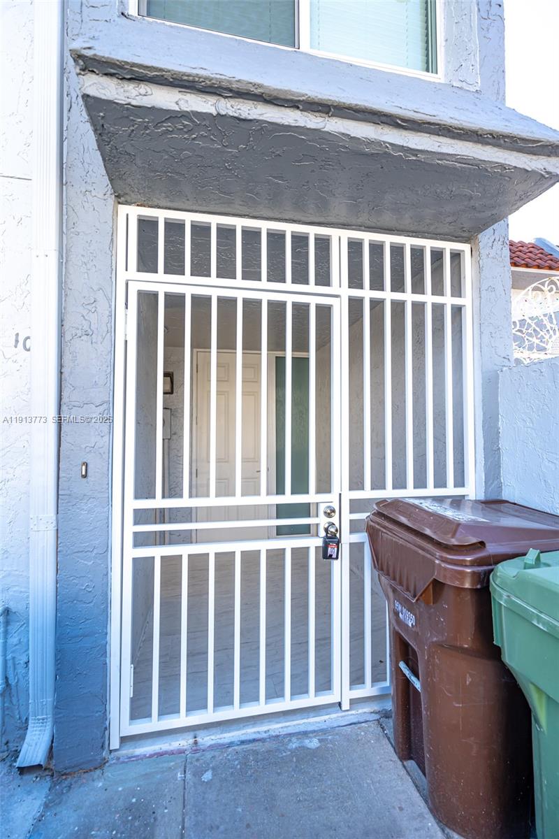 1070 West 43rd Place, Unit 38 Hialeah, FL 33012 - Photo 20 of 25 a view of a door with a balcony