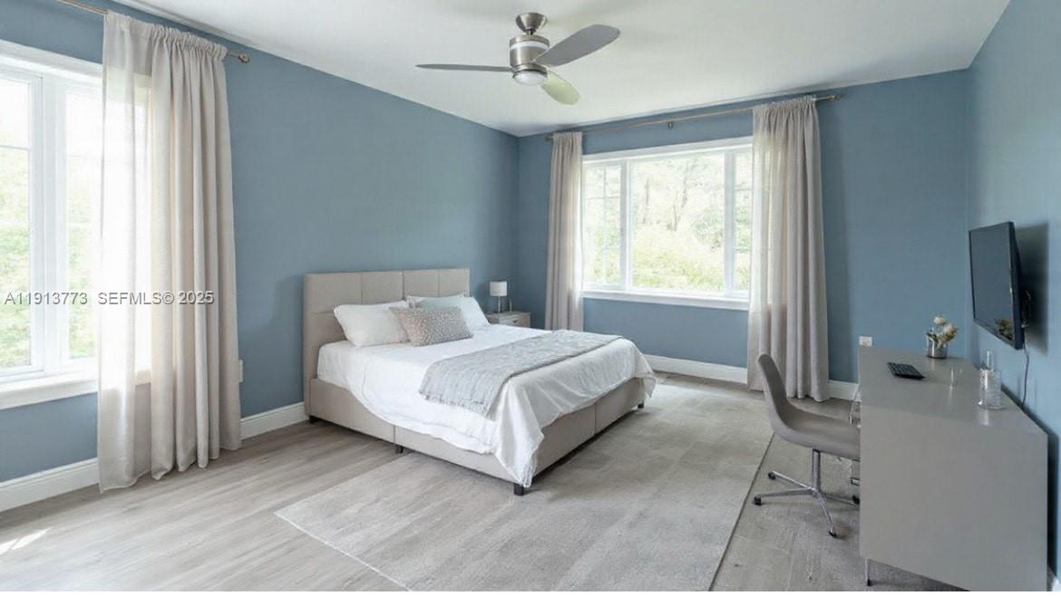 1070 West 43rd Place, Unit 38 Hialeah, FL 33012 - Photo 2 of 25 a bedroom with a bed flat screen tv and window