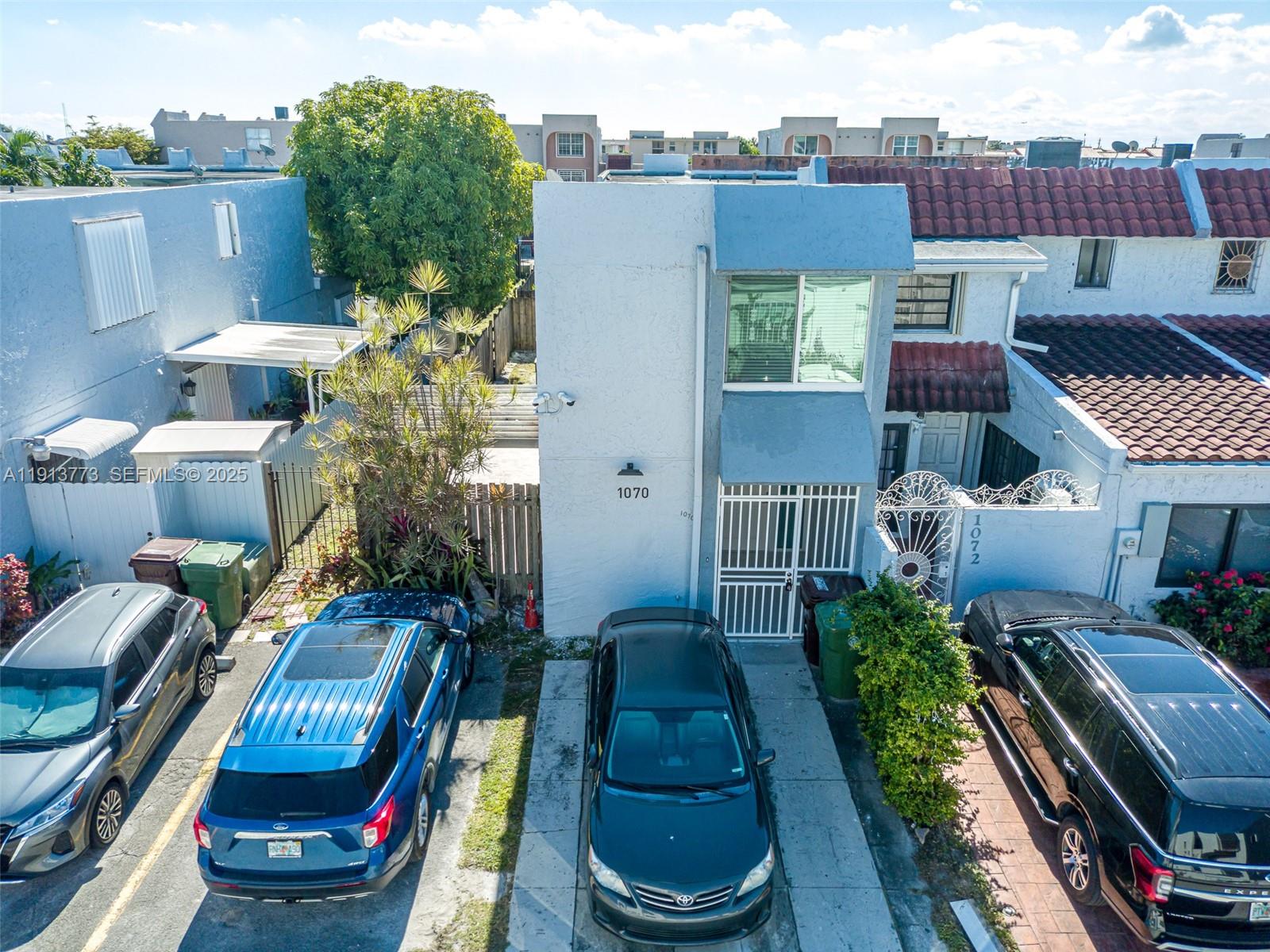 1070 West 43rd Place, Unit 38 Hialeah, FL 33012 - Photo 22 of 25 a front view of a house with outdoor seating