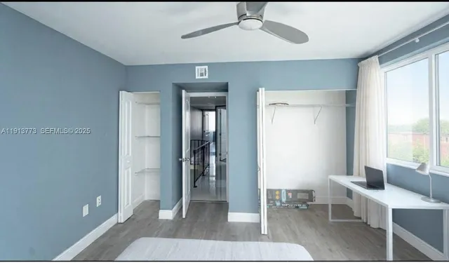 a living room with furniture a window and a ceiling fan