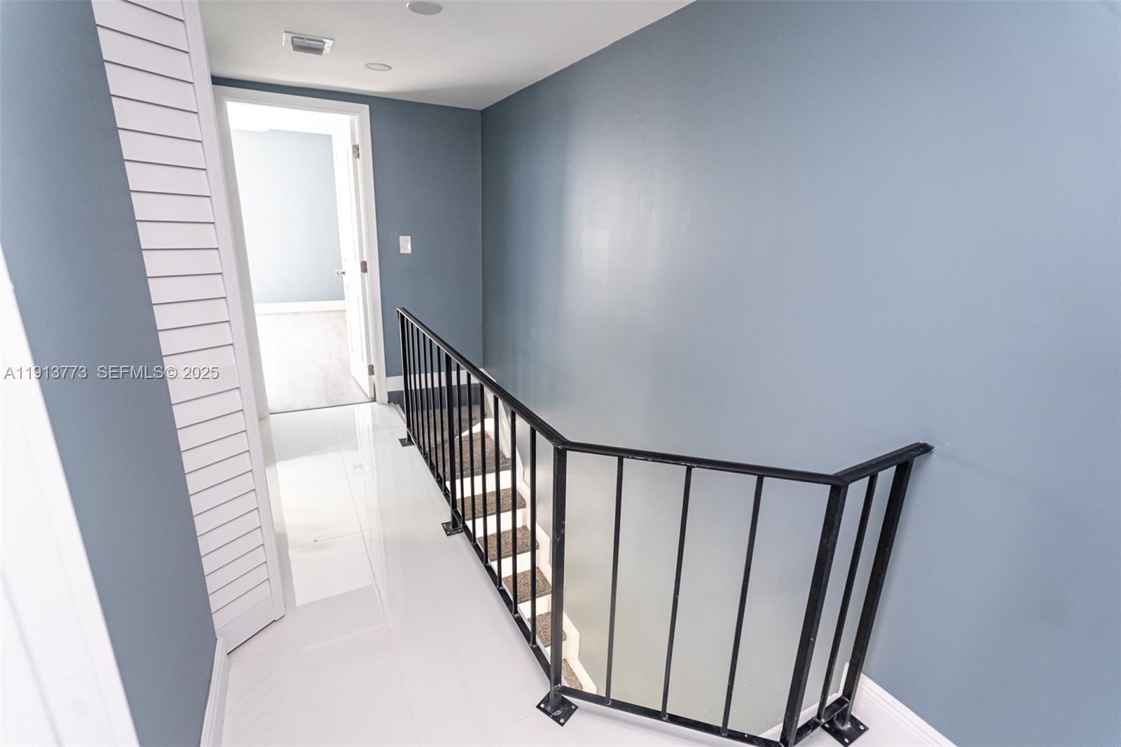 1070 West 43rd Place, Unit 38 Hialeah, FL 33012 - Photo 5 of 25 a view of a hallway with wooden floor and staircase