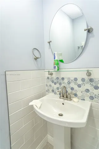 a bathroom with a sink and mirror