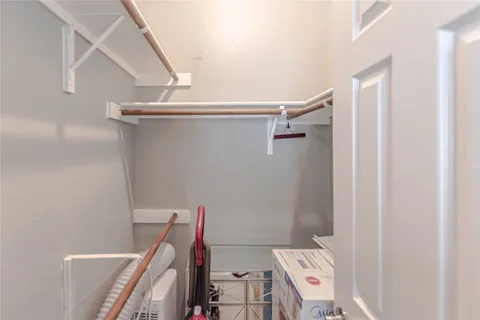 a view of storage and utility room with racks on the wall
