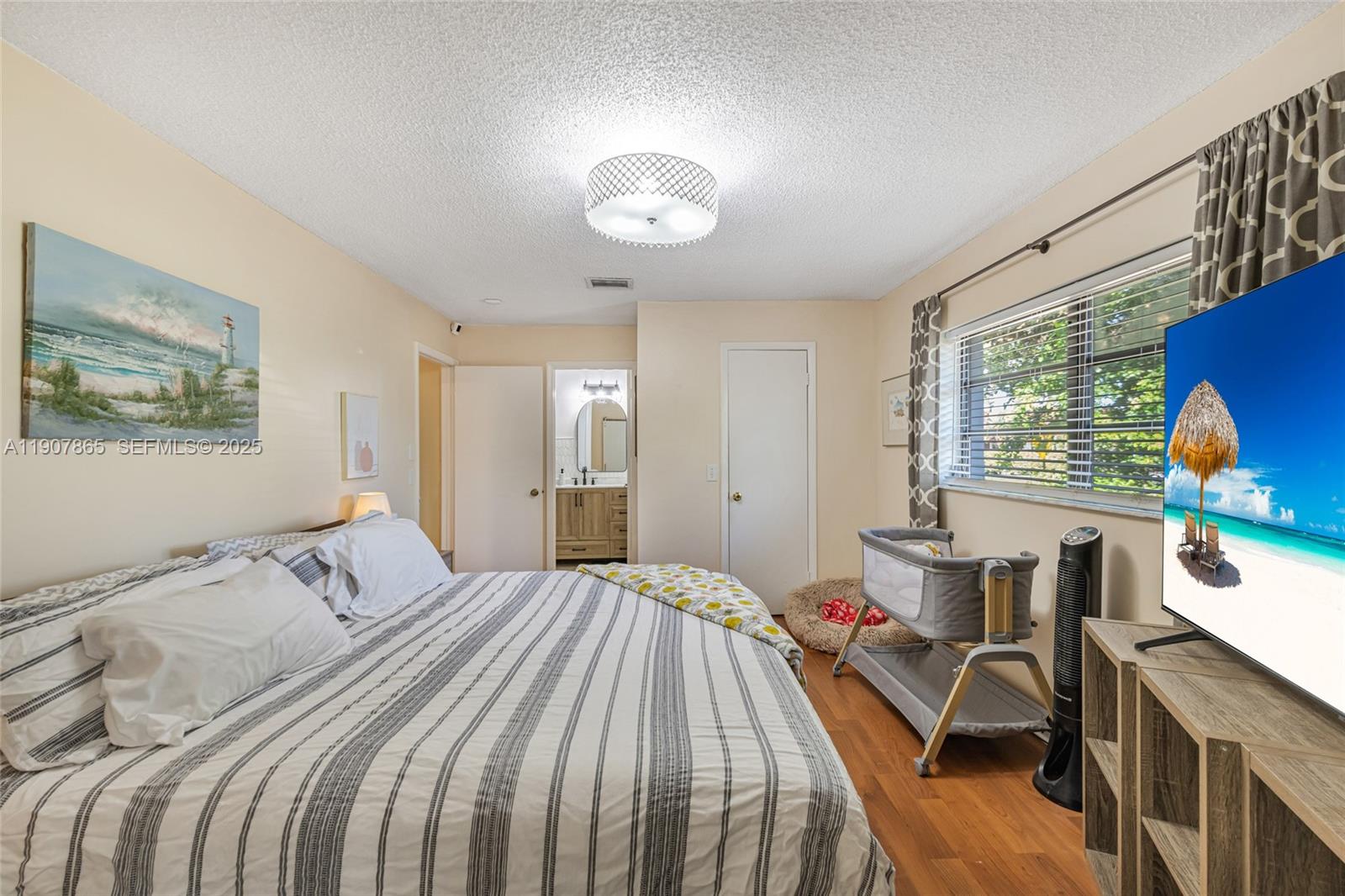 5830 North Park Road Dania Beach, FL 33312 - Photo 12 of 31 a bedroom with a bed and a table in it with window