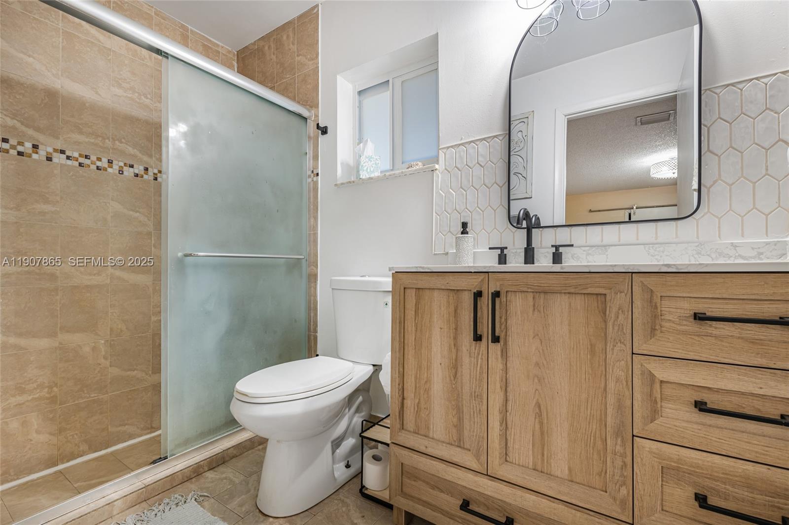 5830 North Park Road Dania Beach, FL 33312 - Photo 13 of 31 a bathroom with a toilet sink vanity and mirror