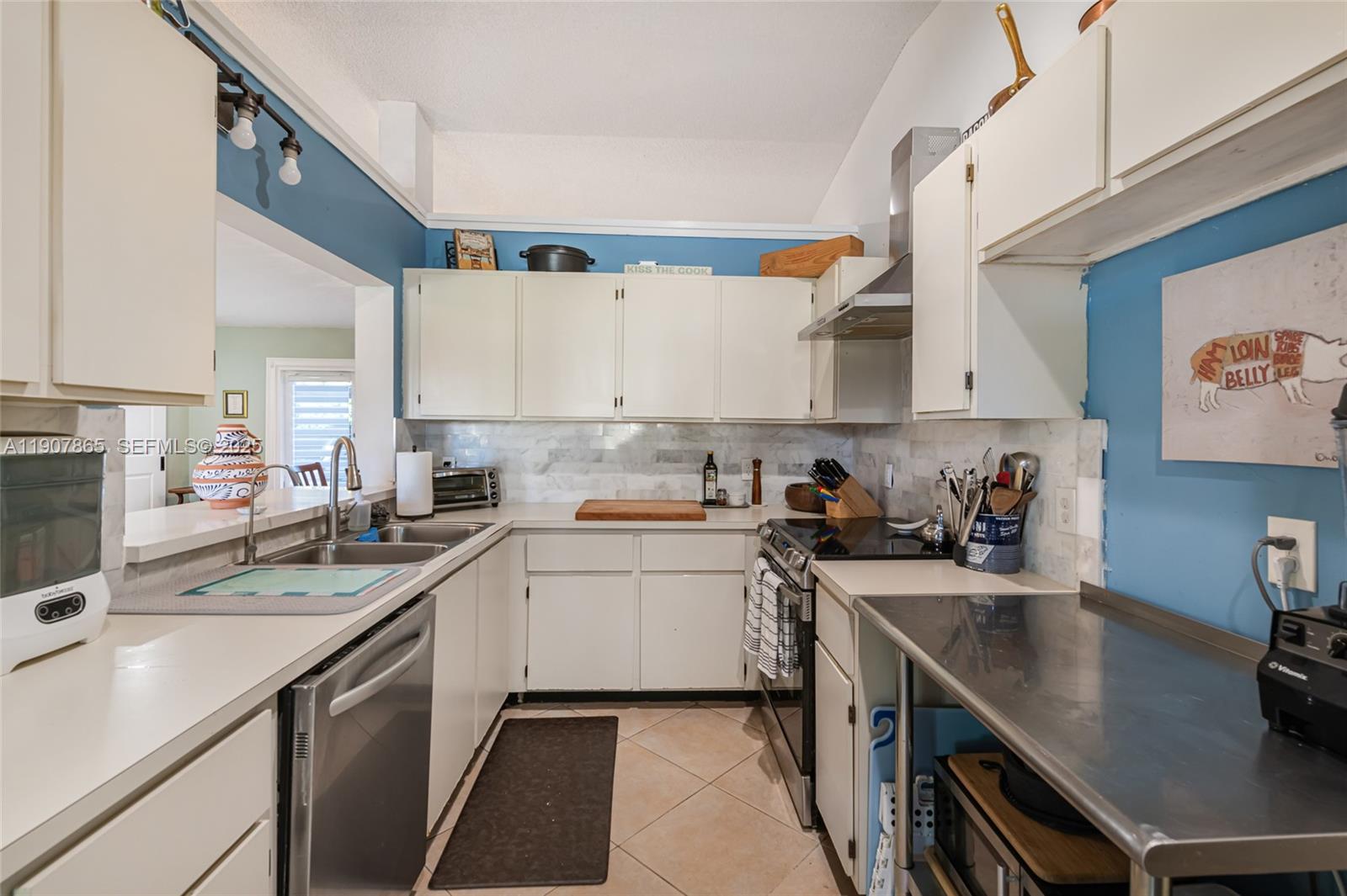 5830 North Park Road Dania Beach, FL 33312 - Photo 22 of 31 a kitchen with a sink a stove cabinets and a window