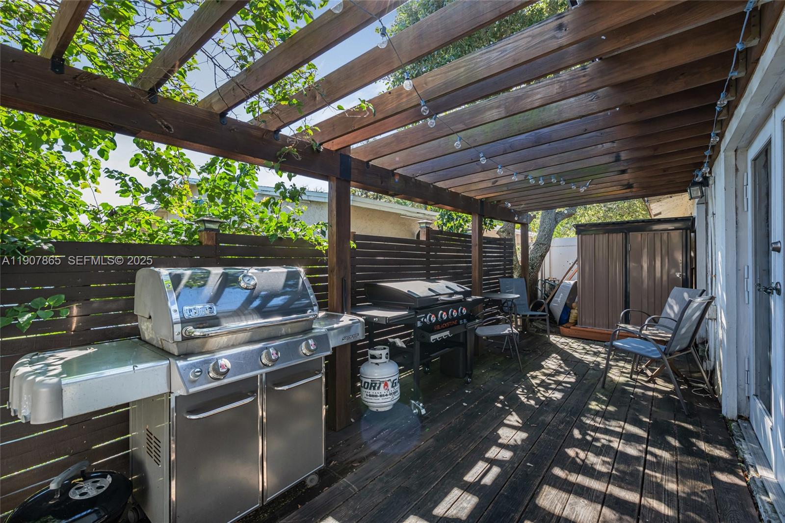 5830 North Park Road Dania Beach, FL 33312 - Photo 27 of 31 a table and chairs sitting in backyard of a house