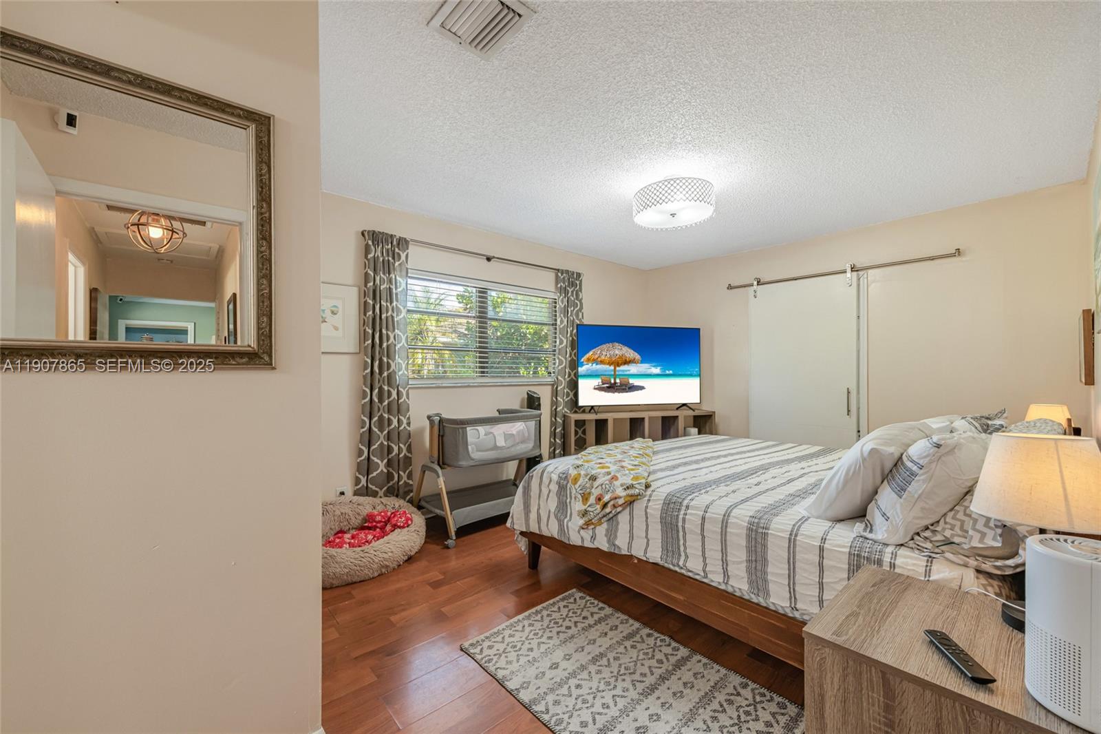 5830 North Park Road Dania Beach, FL 33312 - Photo 9 of 31 a bedroom with a bed and wooden floor