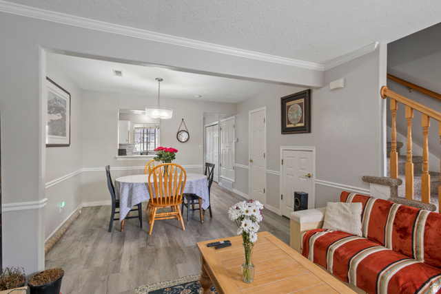 962 Independence Avenue Provo, UT 84604 - Photo 4 of 31 Living room featuring crown molding, wood finished floors, stairway, and a textured ceiling