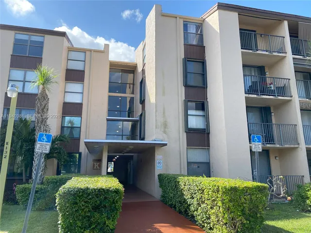 a front view of a building with a garden