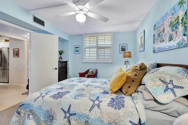 a bedroom with a bed and a painting on the wall