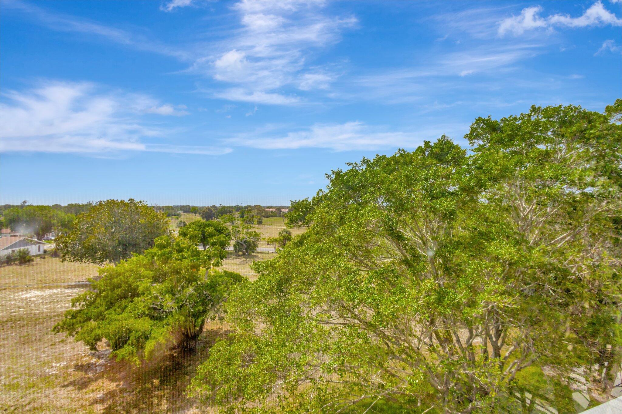 6461 Northwest 2nd Avenue, Unit 512 Boca Raton, FL 33487 - Photo 22 of 22 a view of a field with a tree in the background