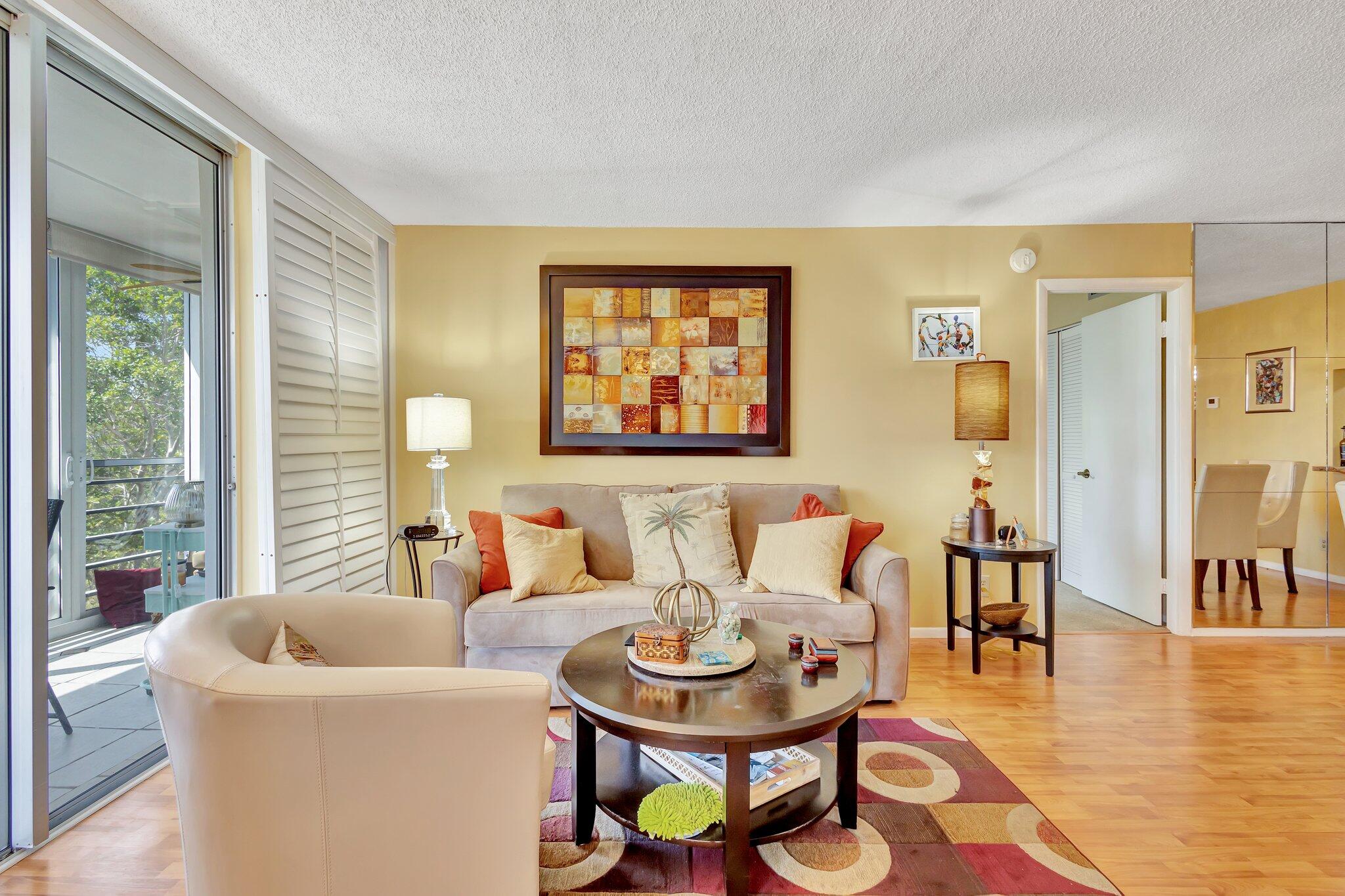 6461 Northwest 2nd Avenue, Unit 512 Boca Raton, FL 33487 - Photo 6 of 22 a living room with furniture and a table