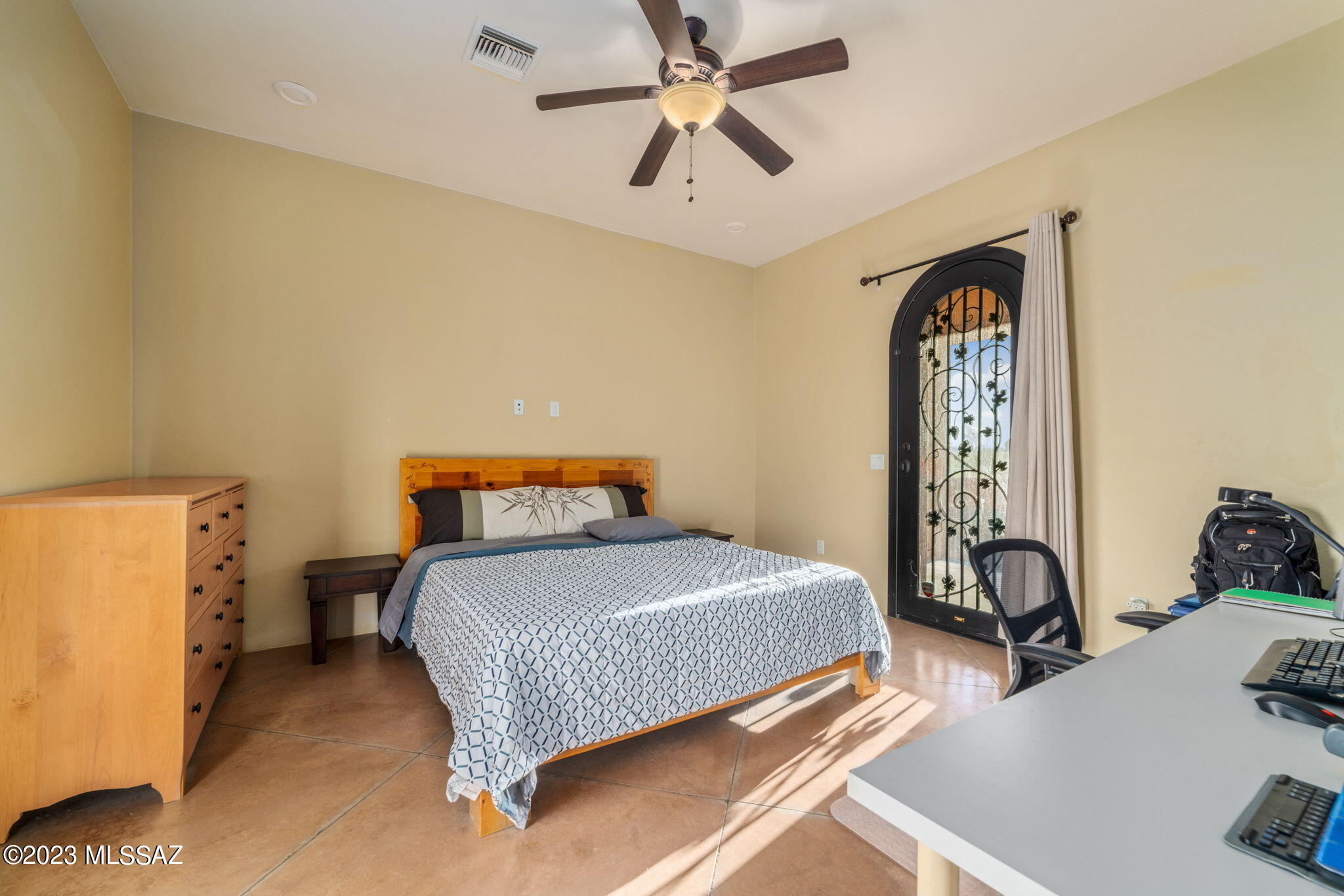 5670 Triangle X Place Tucson, AZ 85713 - Photo 7 of 36 a bedroom with a bed and a chandelier