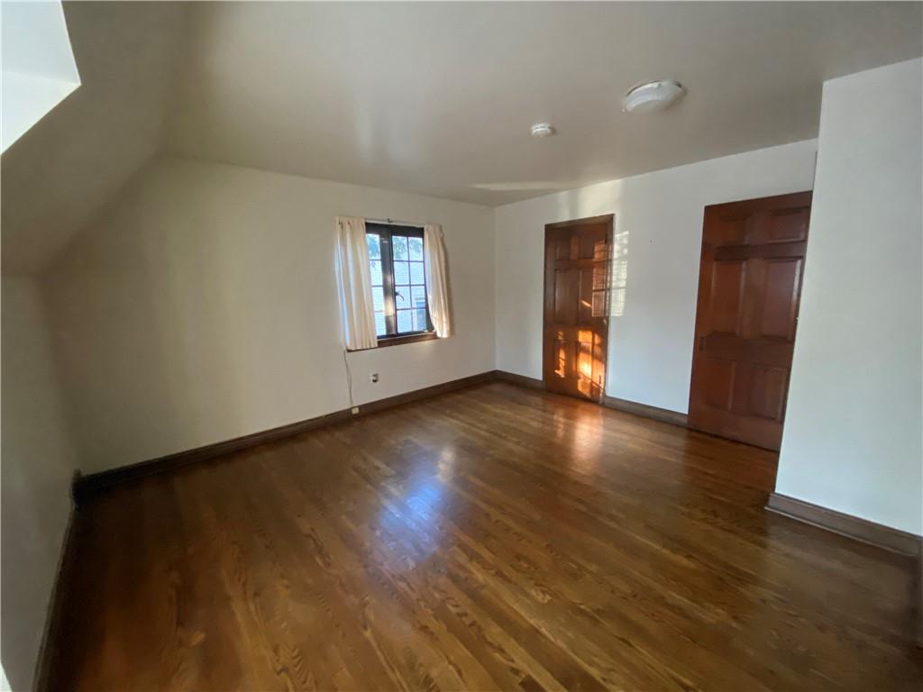 5659 Darlington Road Pittsburgh, PA 15217 - Photo 12 of 23 an empty room with wooden floor and windows